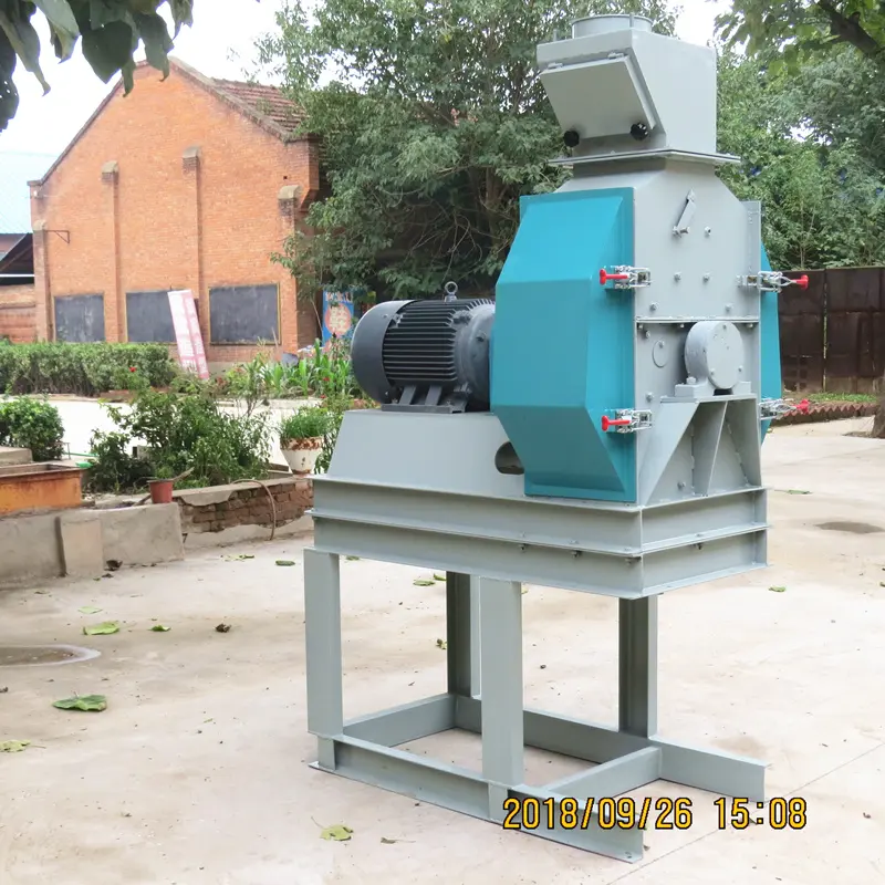 Feed crusher machine operating in livestock feed production plant